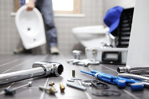 Plumber at Work in a Bathroom — Plumber in Armidale, NSW