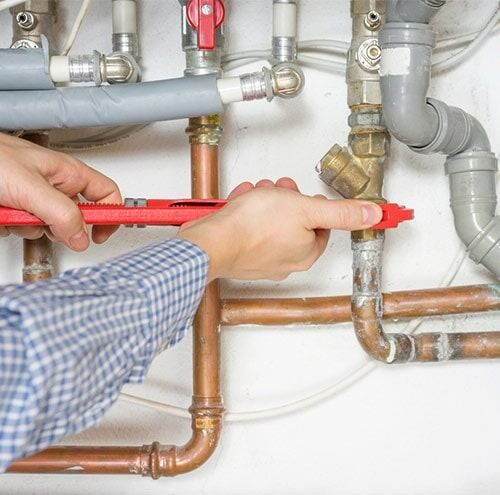 Plumber Fixing Central Heating System — Gas Hot Water Systems in Armidale, NSW