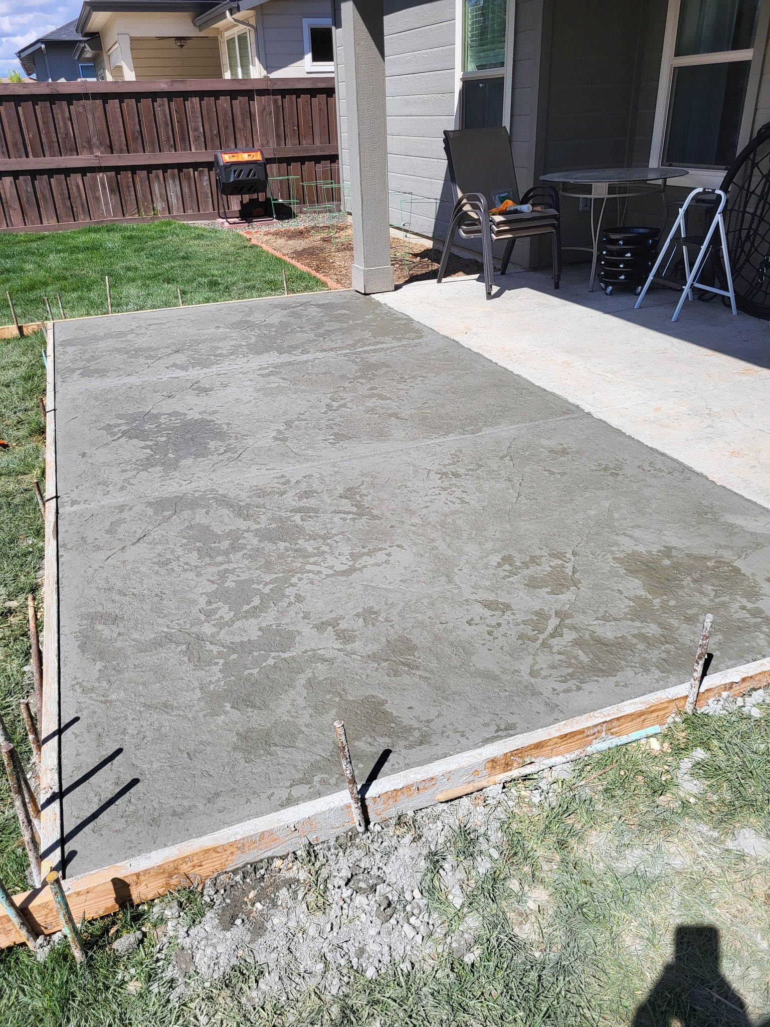 Worker smoothing out sidewalk crack filler on walkway, installed by Waypoint Concrete in Garden City, ID.
