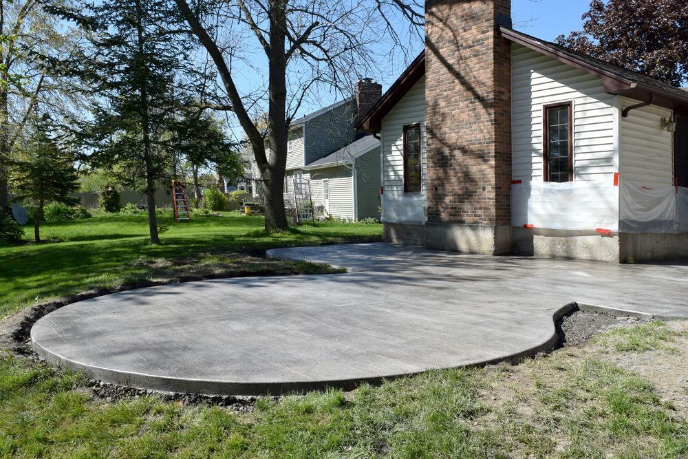 Waypoint Concrete installed a round broom-finish concrete patio for a backyard entertainment space in Caldwell, Idaho.