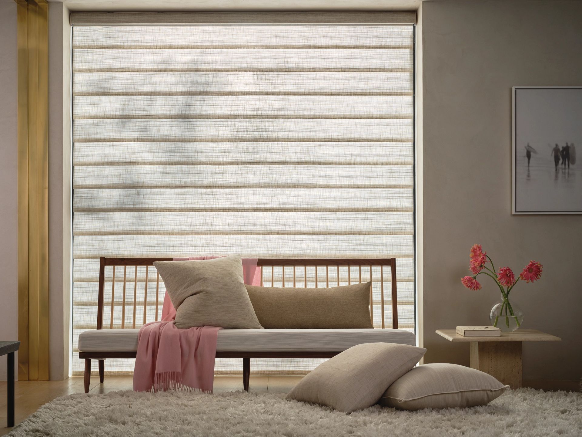 Living room with beige roman shades, a wooden bench with pillows, and a fluffy rug.