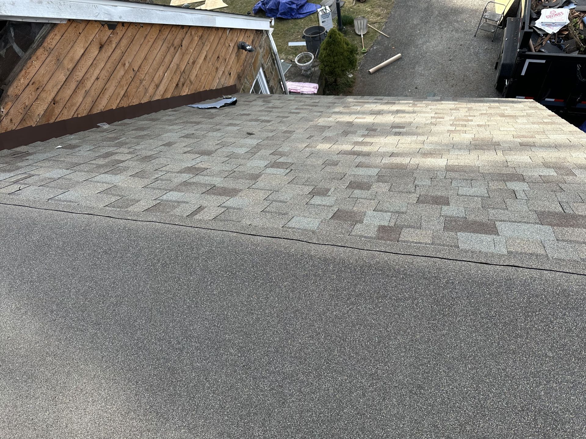 A roof with shingles being installed on a house.