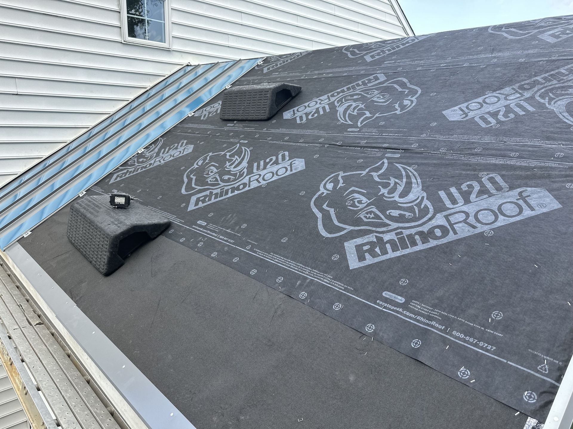 A rhino roof is being installed on the roof of a house
