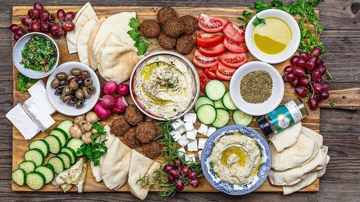 There are many different types of food on the cutting board.
