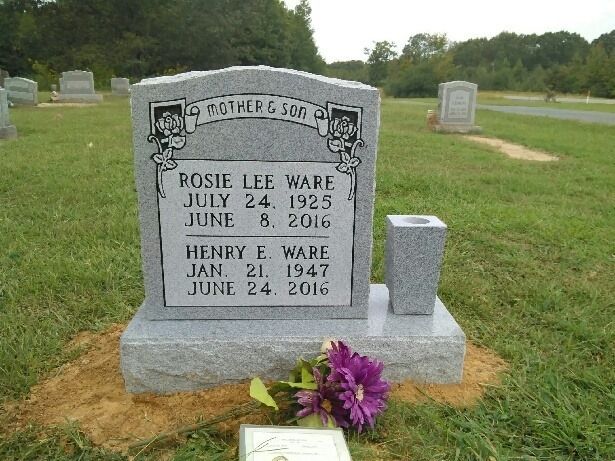 A grave in a cemetery with a vase and flowers