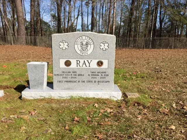 A Gravestone for Ray in a Cemetery with Trees in the Background – Canton, MS – Davidson Marble & Granite