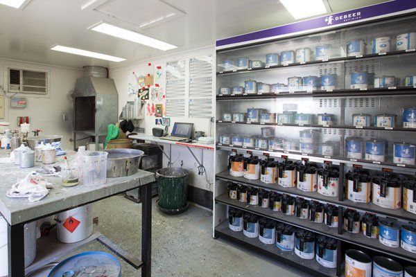 A Paint Mixing Room and a Display of Paint Cans — Mid City Smash Repairs in Dubbo, NSW