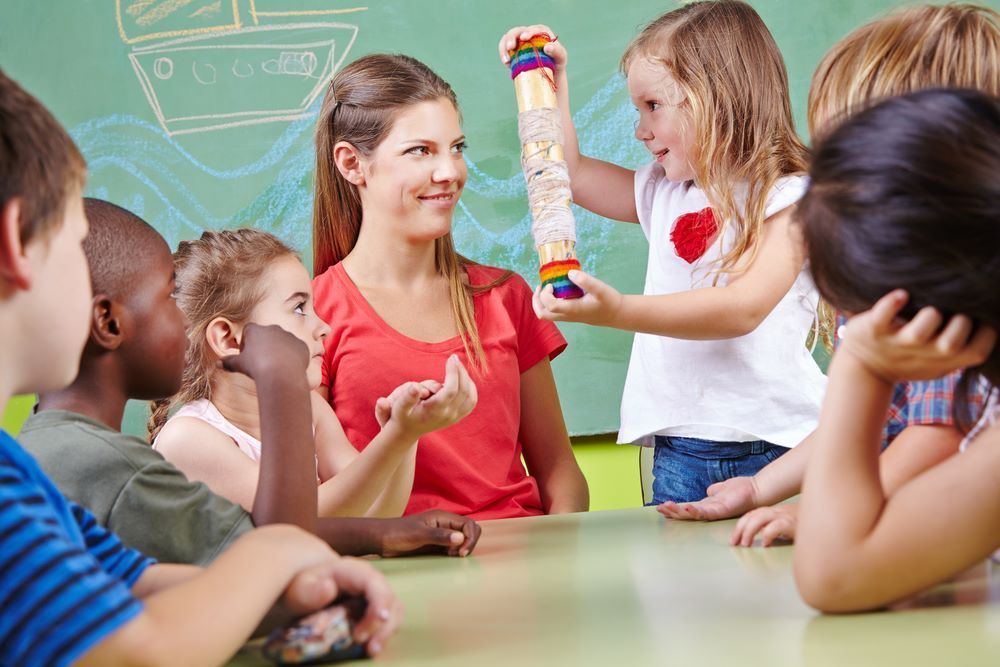 A teacher is teaching a group of children in a classroom — Grandma Rosie’s Quality Long Day Care In Dapto, NSW