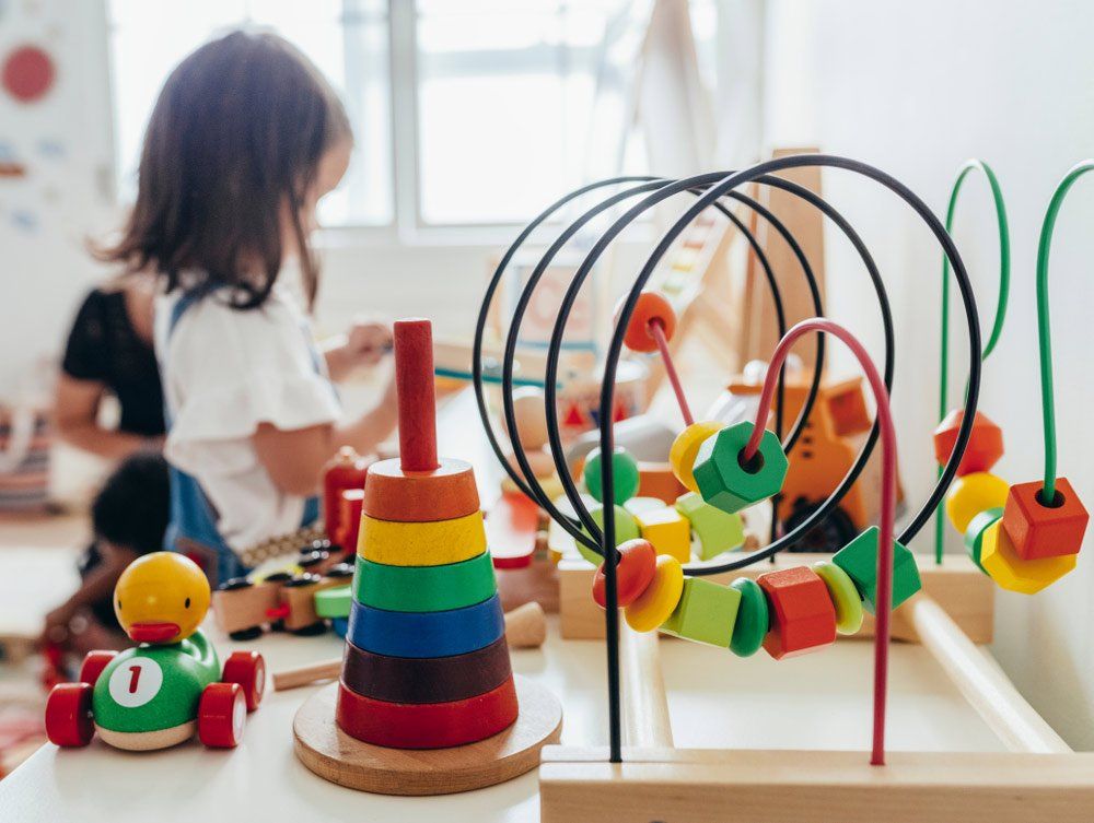 Young Girl Playing With Educational Toys — Grandma Rosie’s Quality Long Day Care In Wollongong, NSW