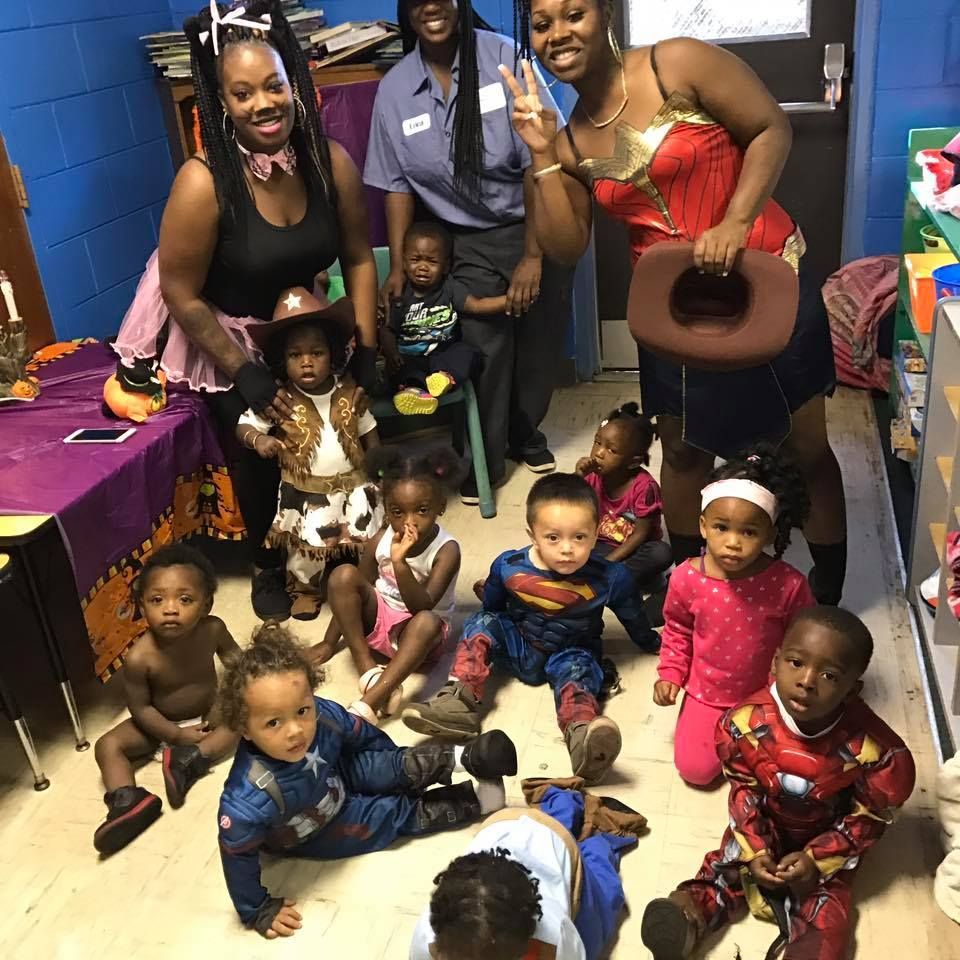 A group of children dressed in costumes are posing for a picture.