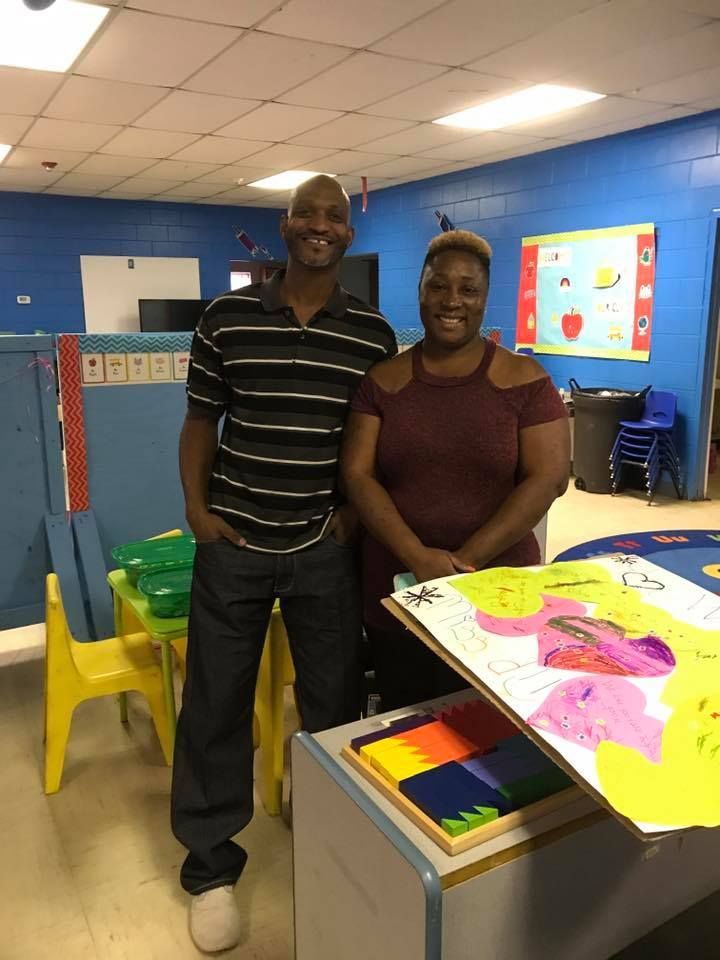 A man and a woman are standing next to each other in a room