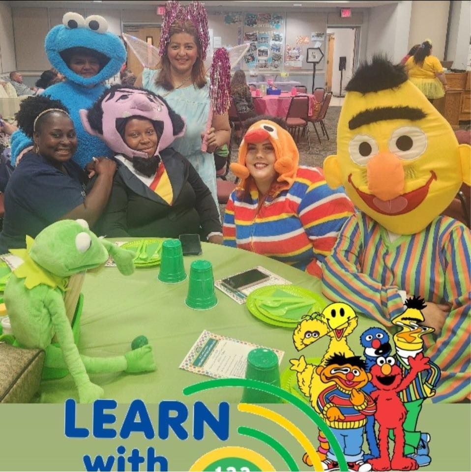 A group of sesame street characters sitting around a table