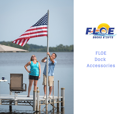 A man and woman standing on a dock holding an american flag
