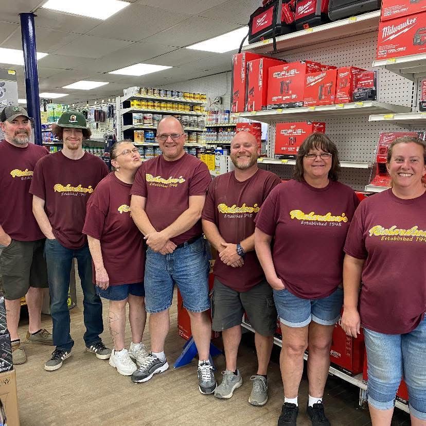 A group of people wearing maroon sweatshirts with the word rhode island on them