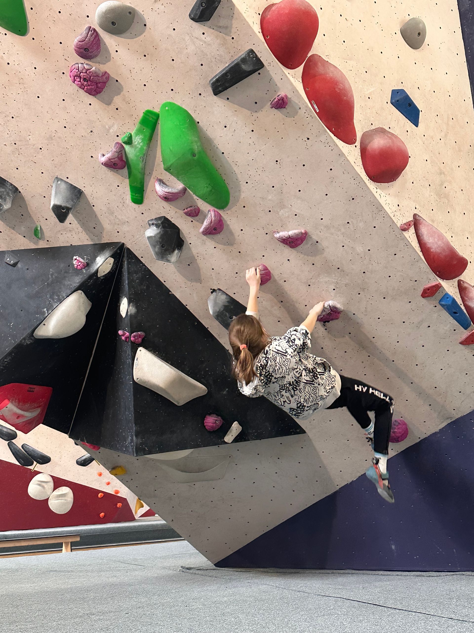 Iemand beklimt een klimwand in een sportschool.