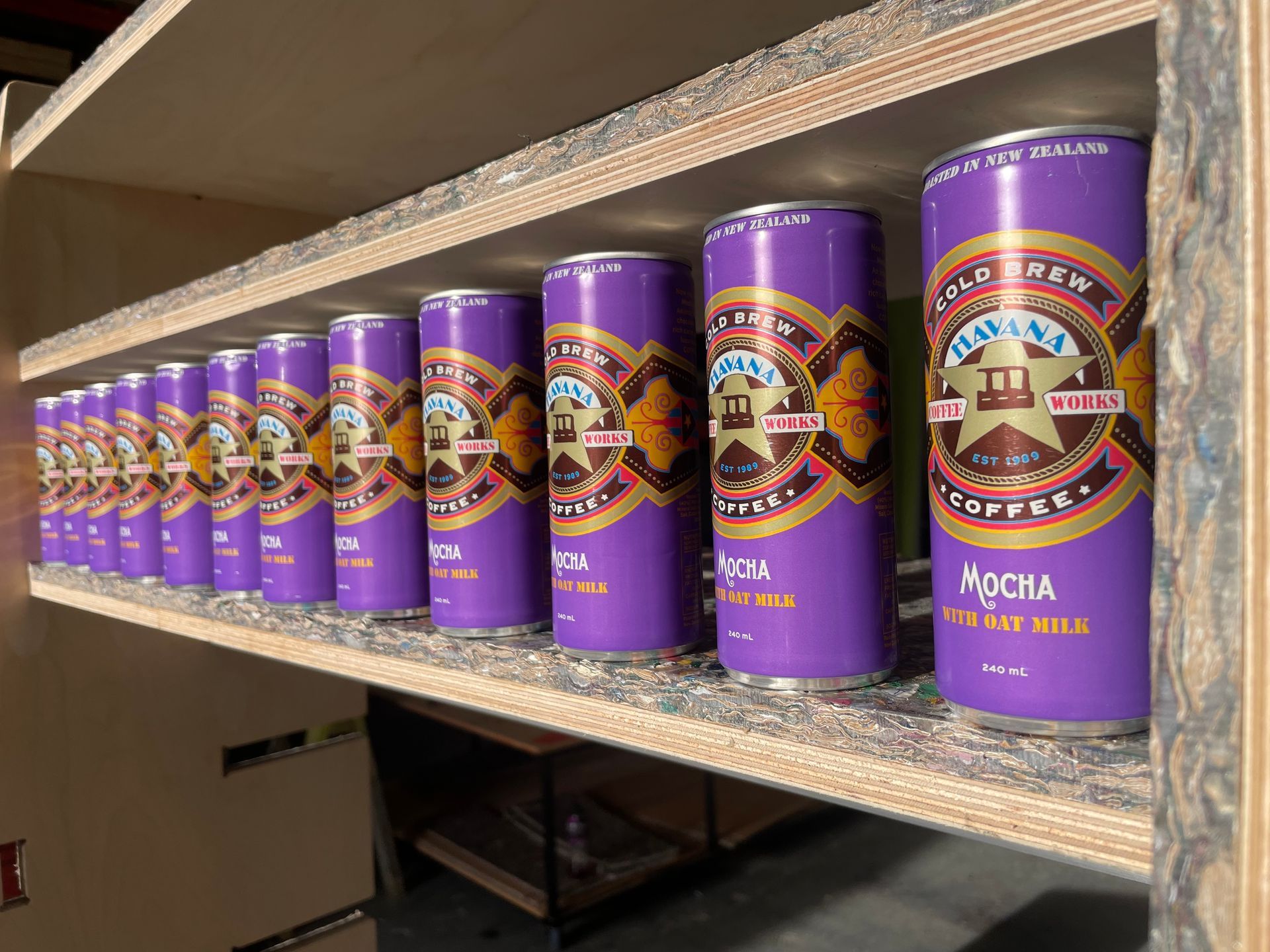 Rows of Havana canned coffee, displayed on wooden shelves.