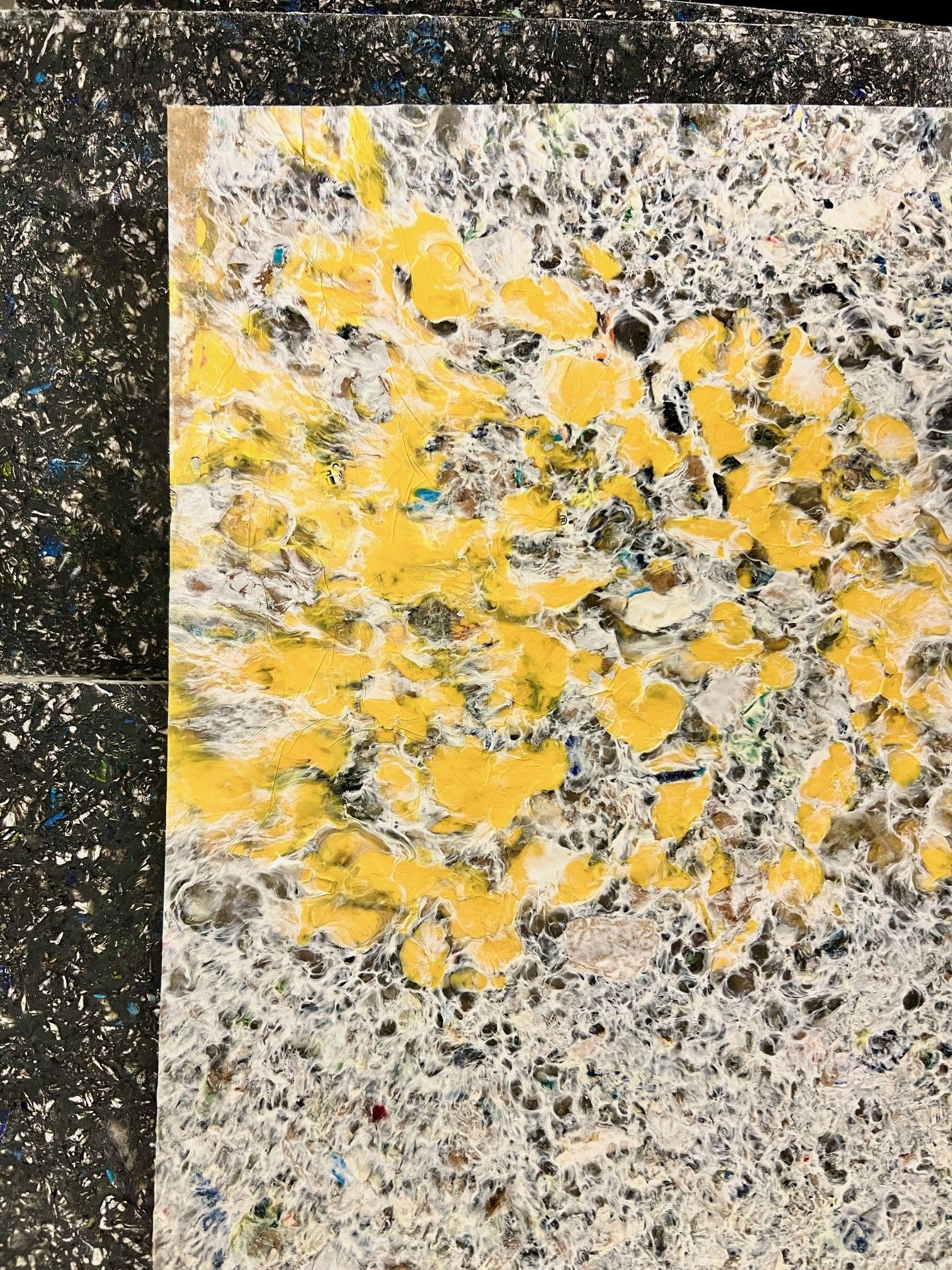 saveBOARD. White, gray, and yellow mottled surface. A blotch of yellow splotches over a gray speckled background.