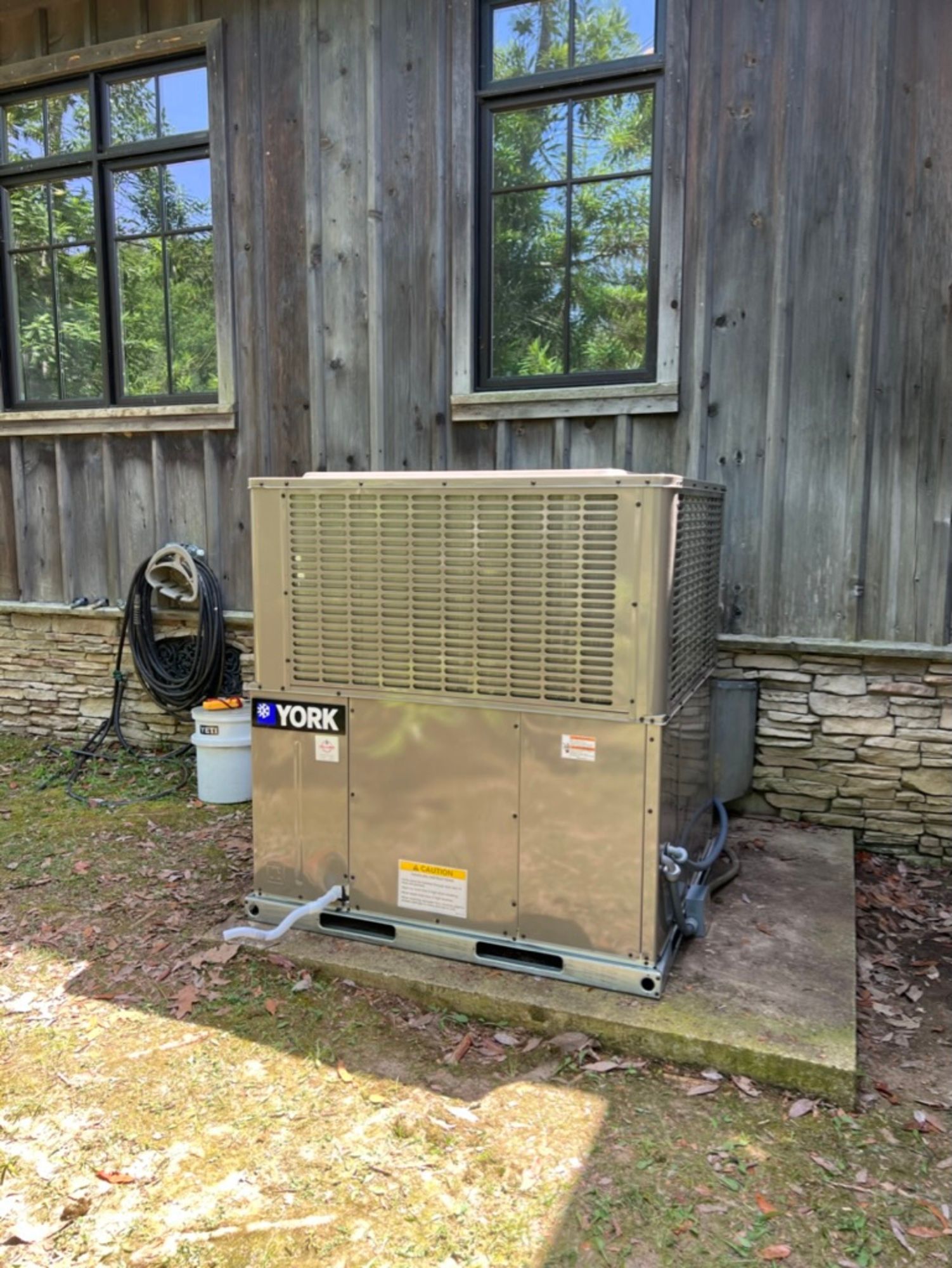 Emergency Services repair and replace white outdoor door A york air conditioner is sitting outside of a wooden building.