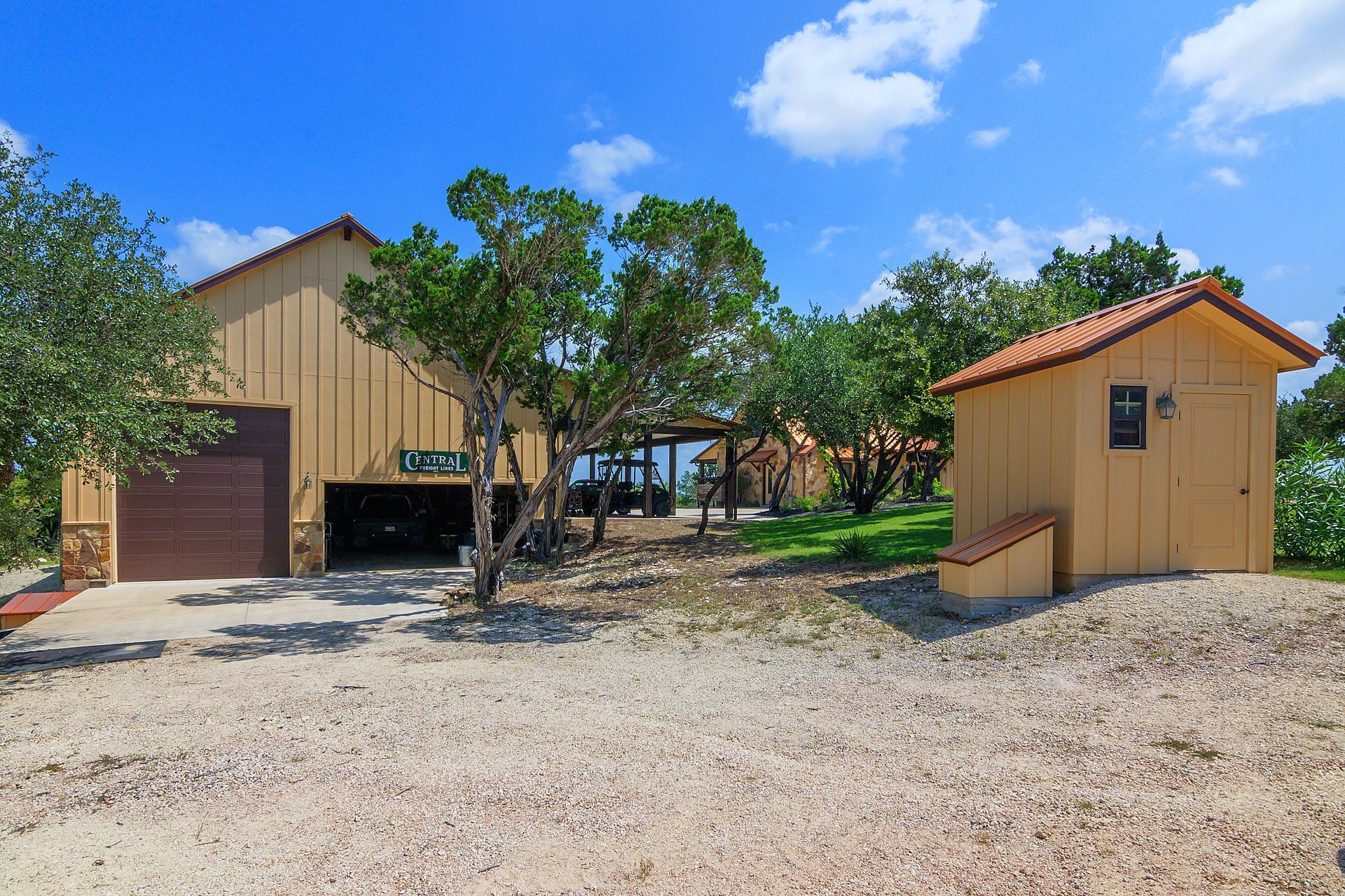 A house with a garage and a shed in front of it