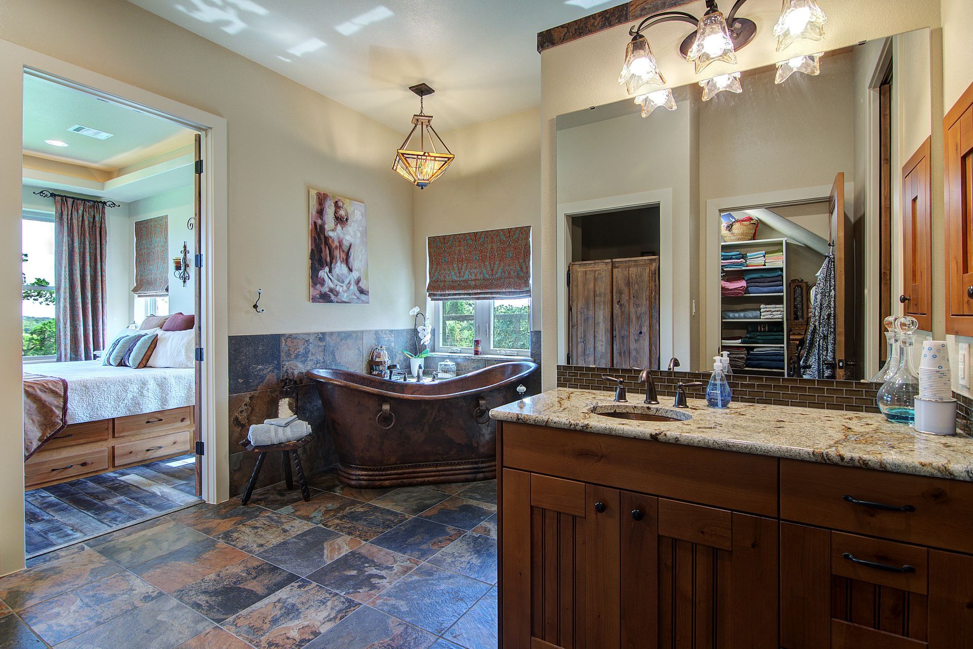 A bathroom with a copper tub , sink , and mirror.