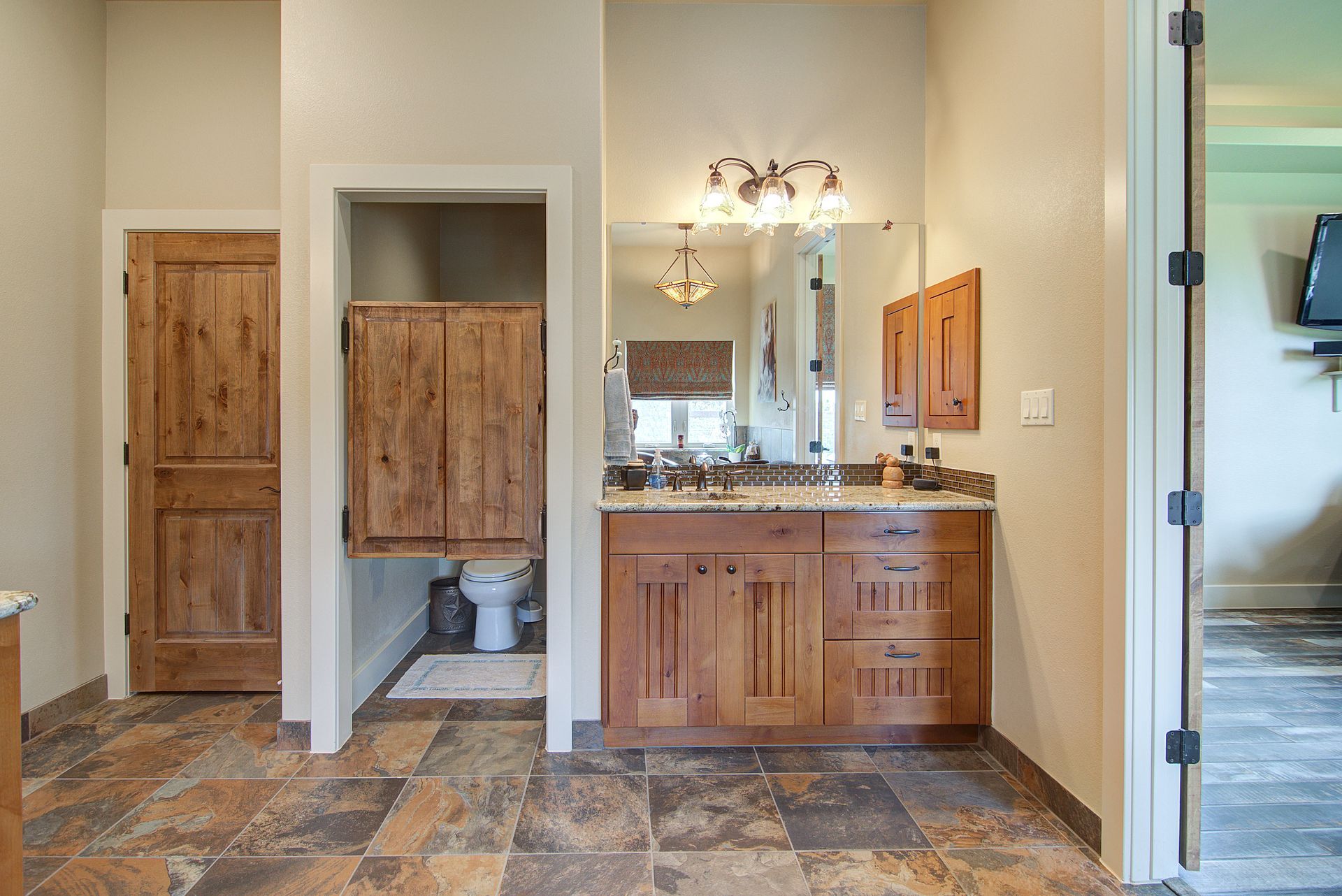 A bathroom with a double sink and a toilet.