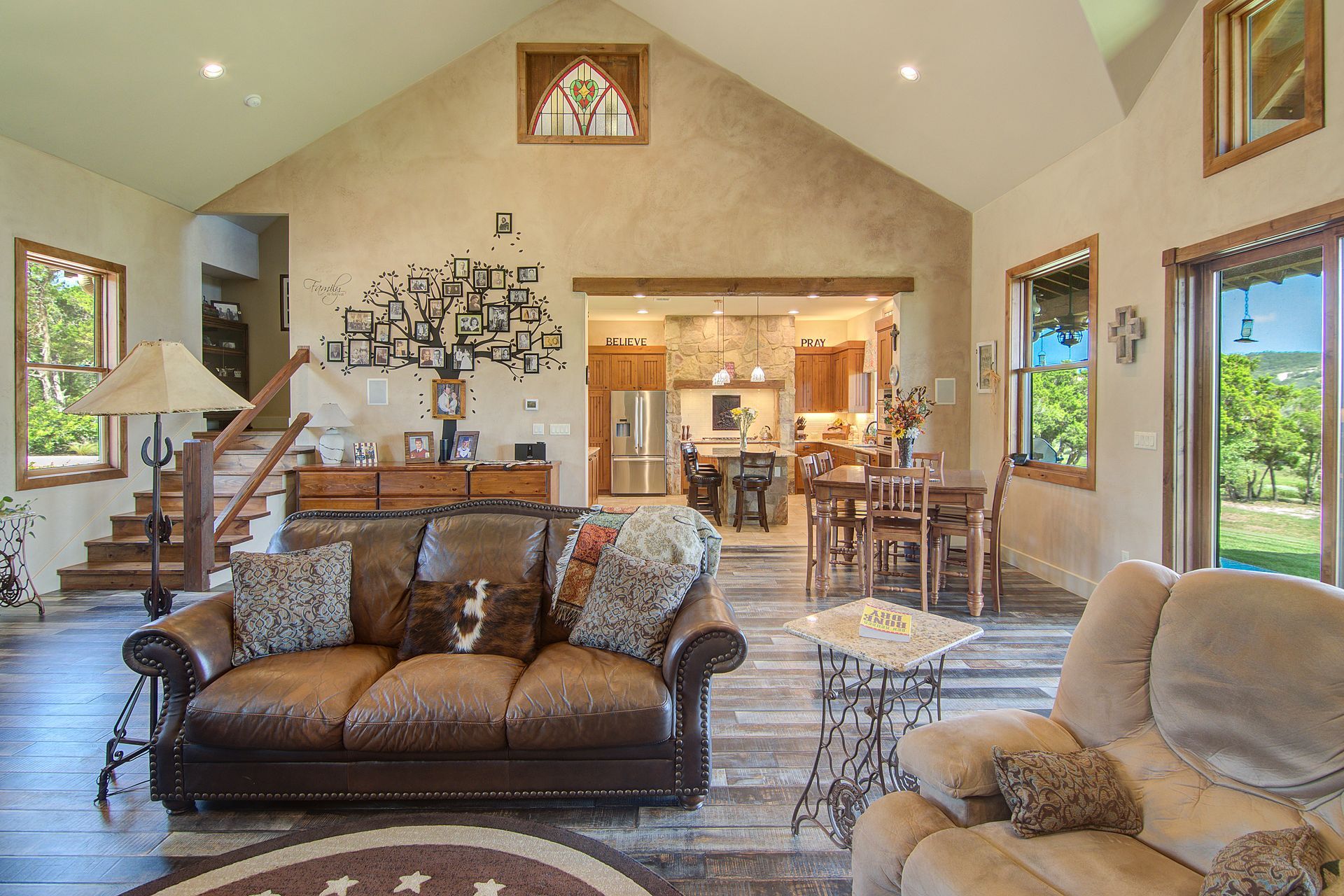 A living room filled with furniture and a vaulted ceiling.