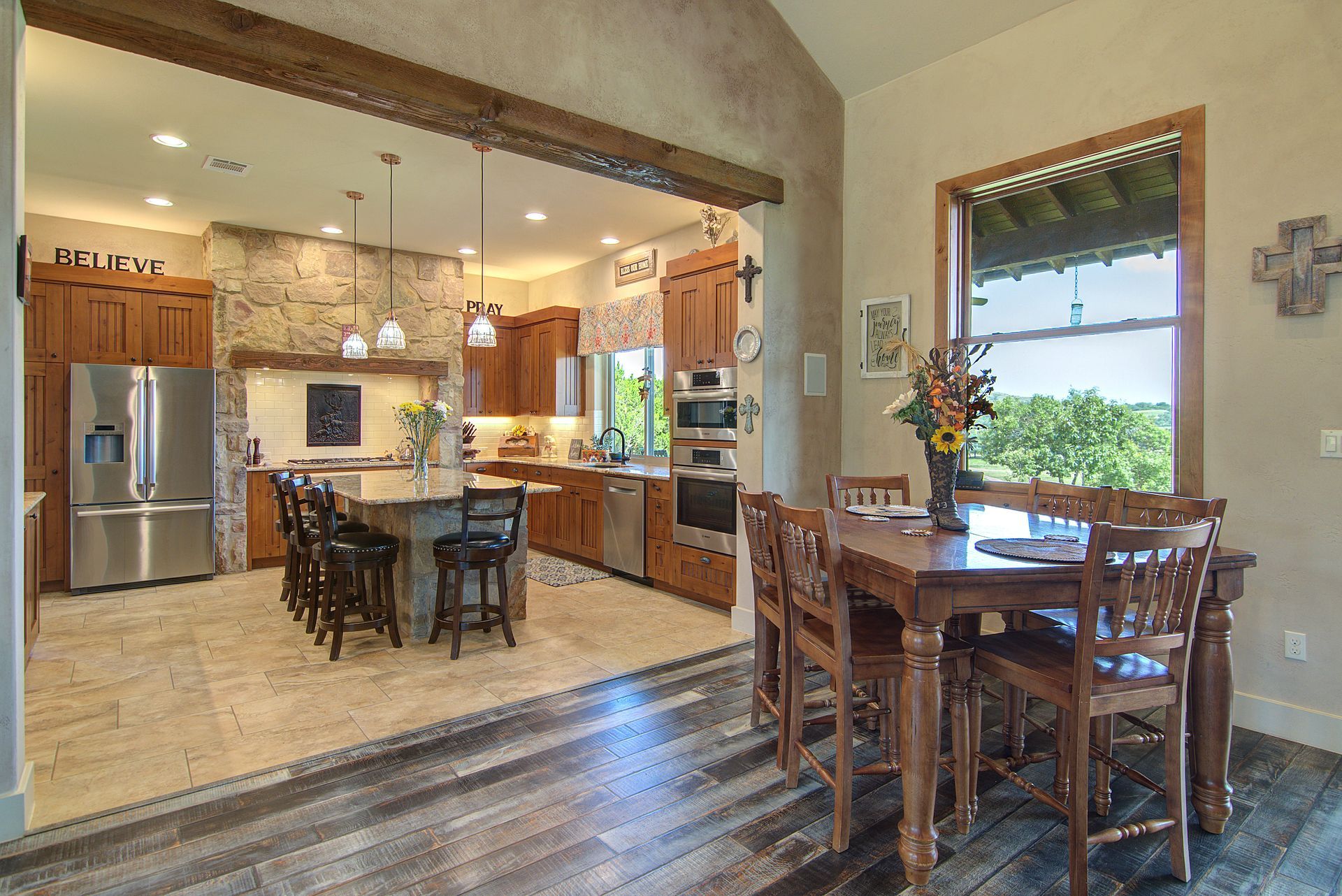 A kitchen and dining room in a house with a table and chairs.