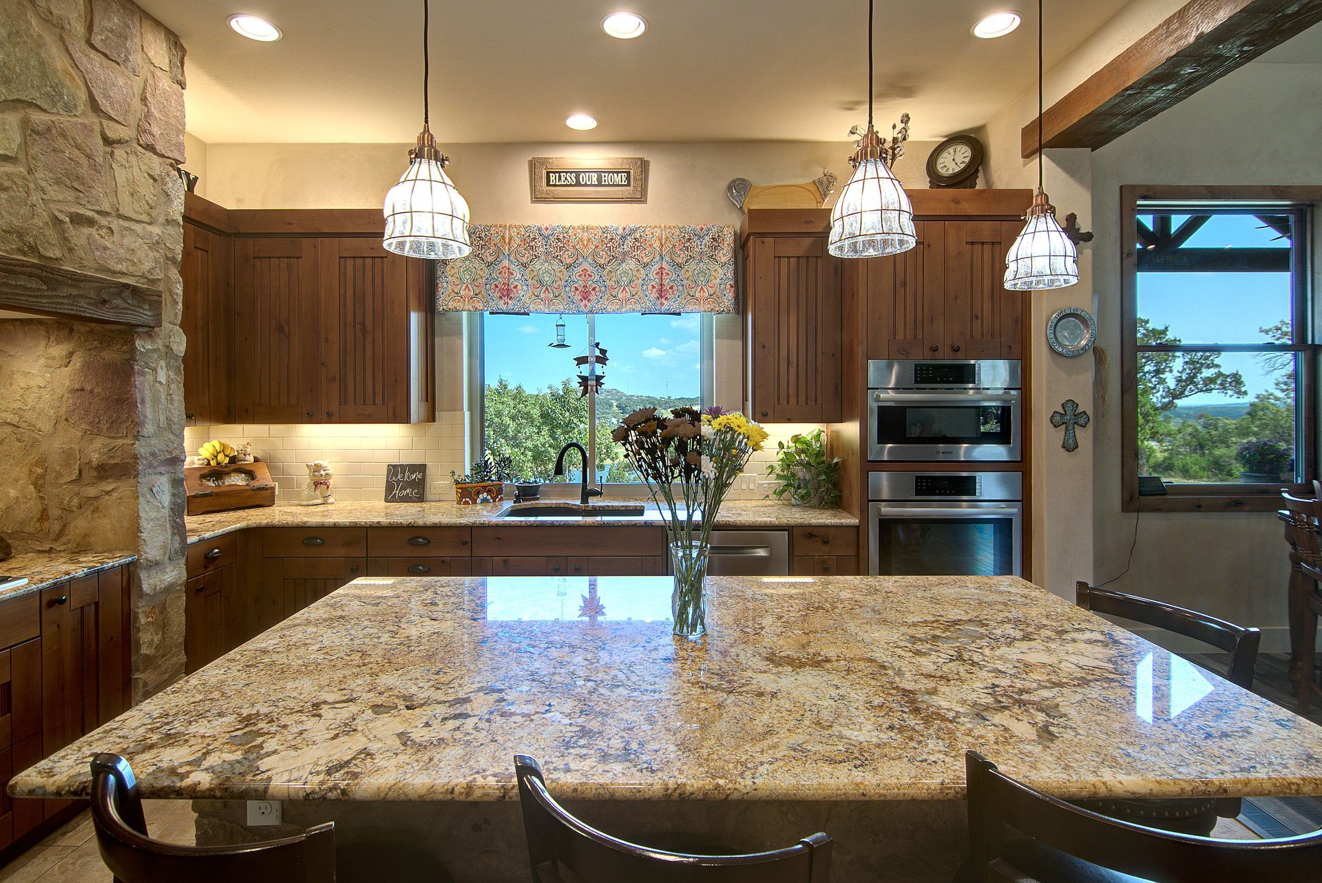 A kitchen with granite counter tops and stainless steel appliances