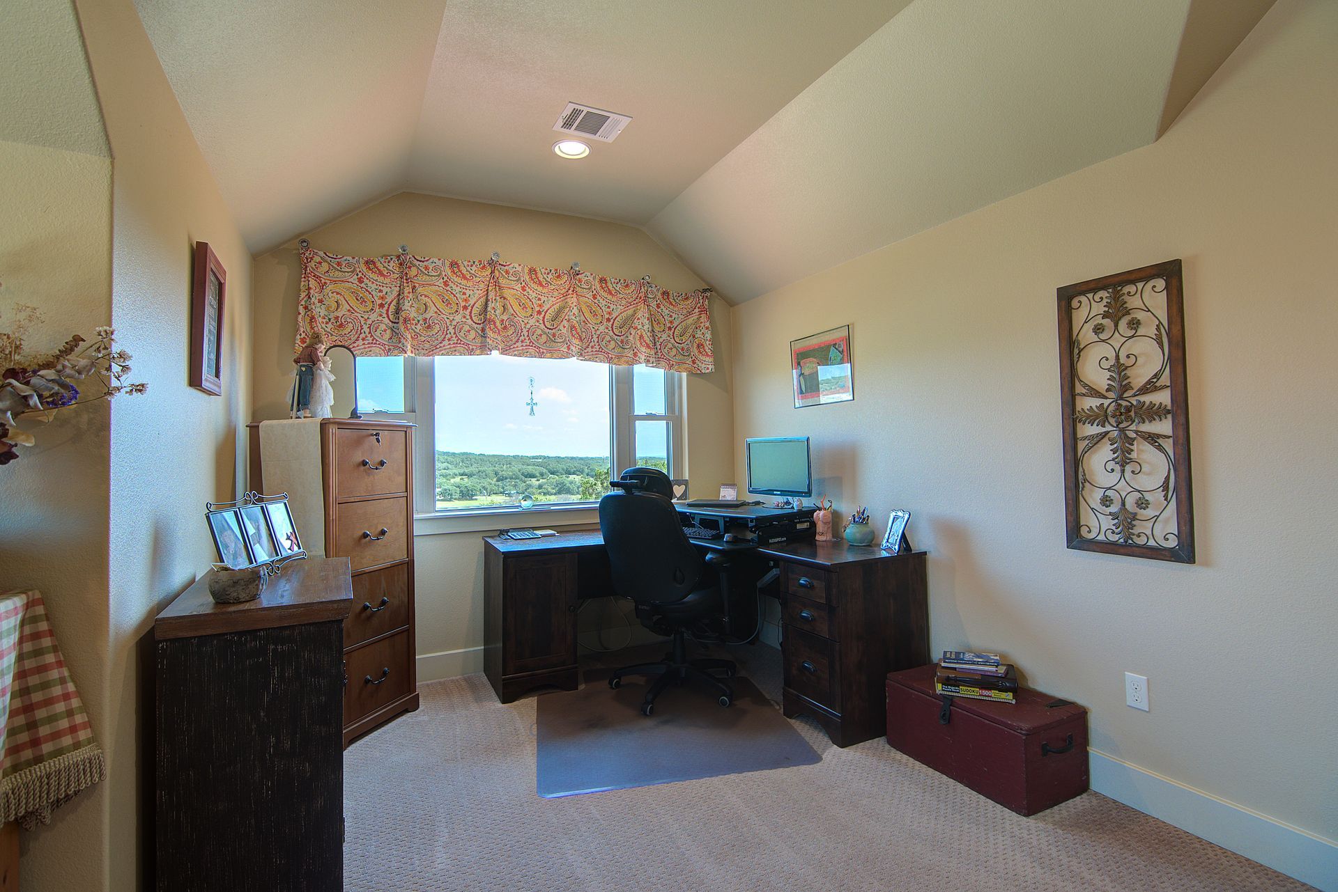 A room with a desk and chair and a window