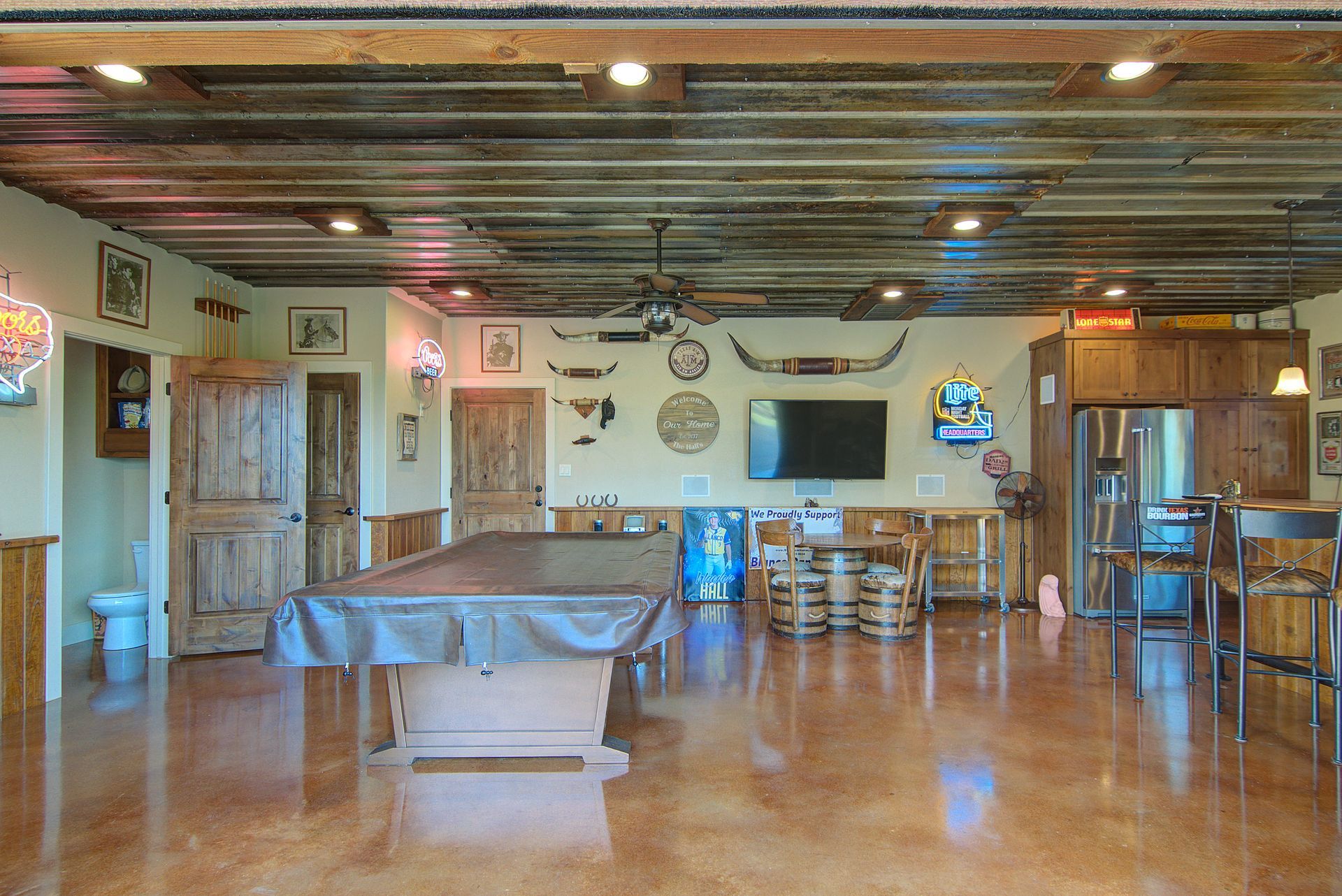 There is a pool table in the middle of the room.