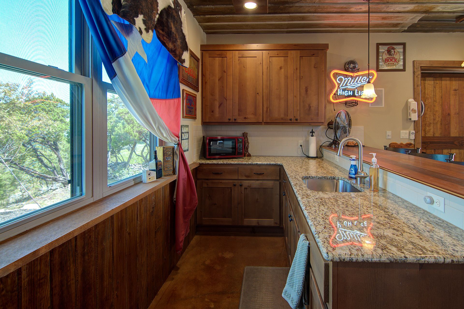 A kitchen with a sign that says bud light on it