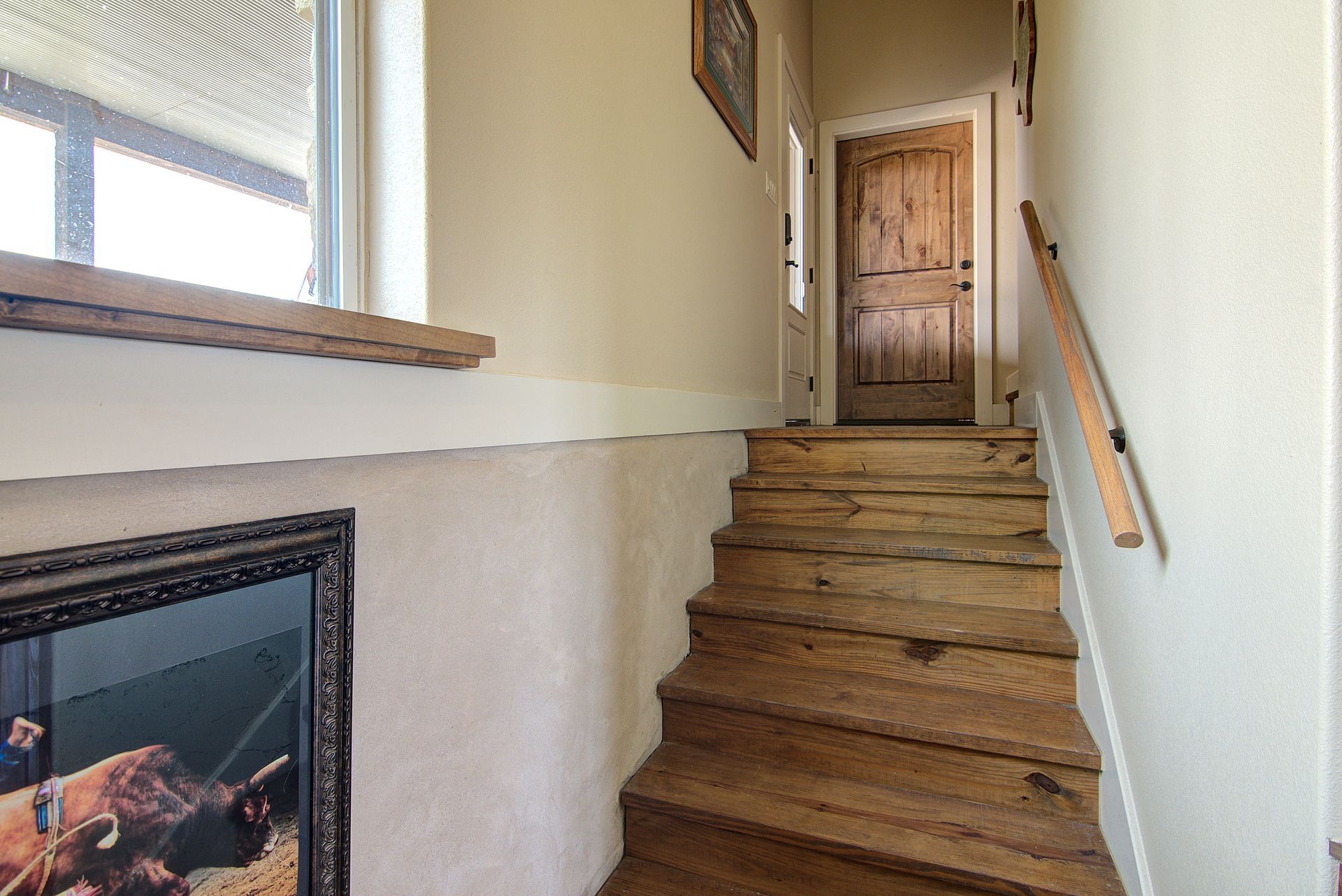 A wooden staircase leading up to the second floor of a house.