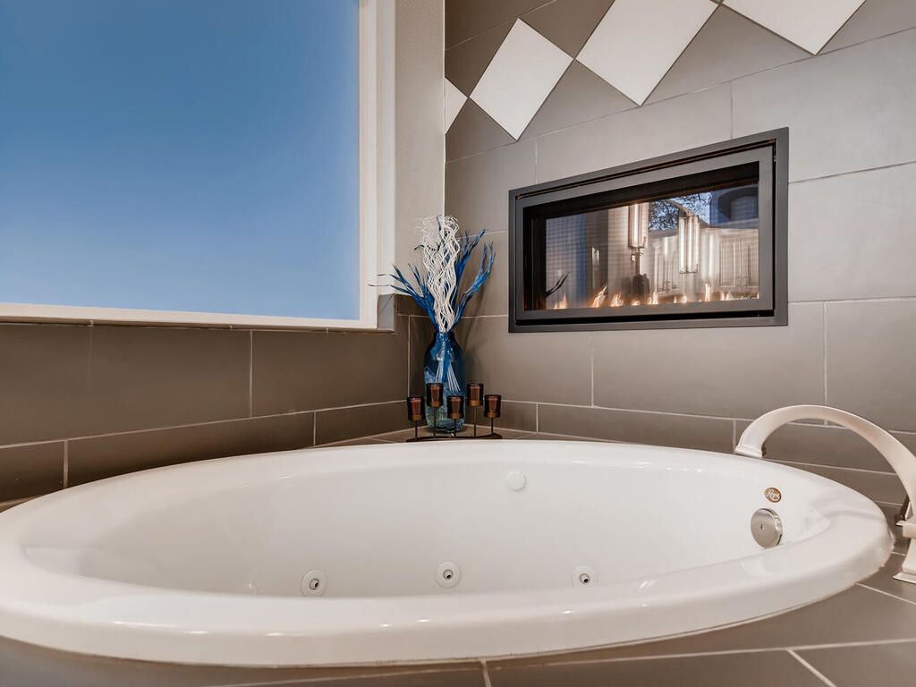 A bathroom with a jacuzzi tub and a fireplace