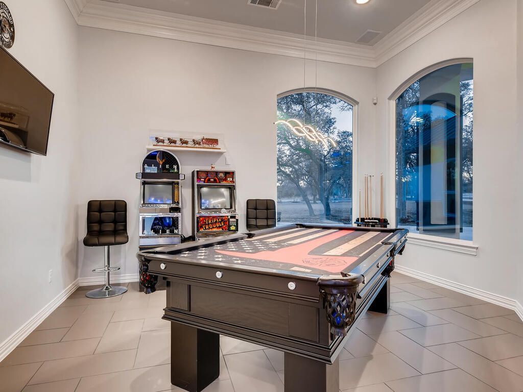 There is a pool table in the middle of the room.