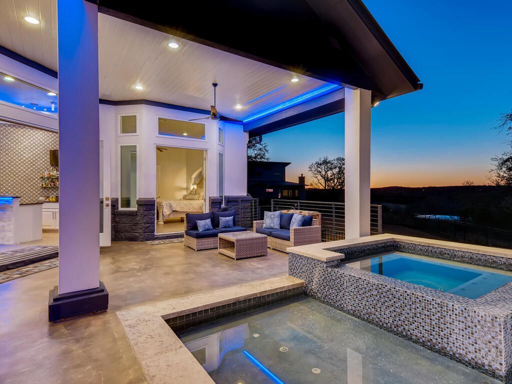 There is a swimming pool in the middle of the patio area.