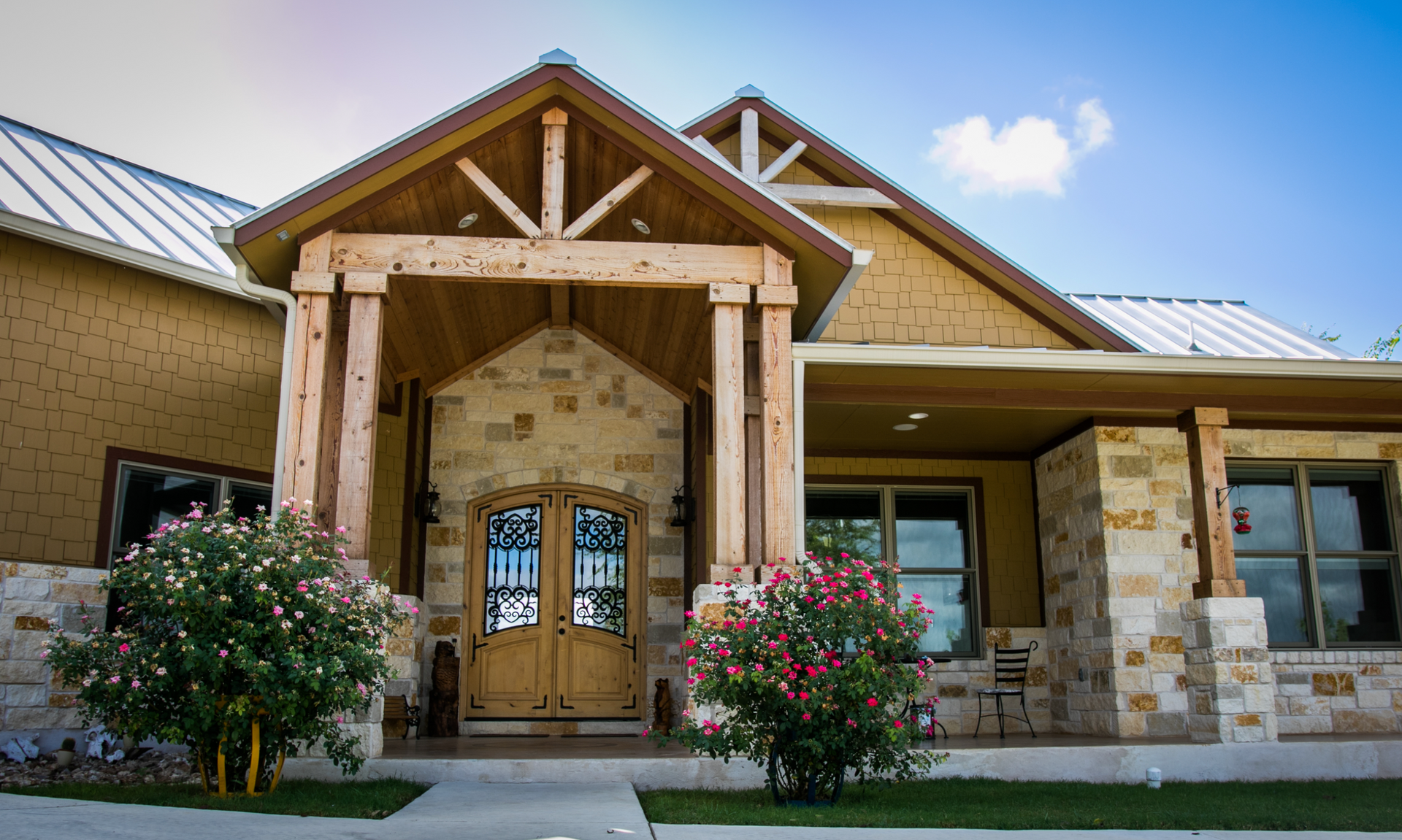 A large house with a wooden porch and a metal roof.
