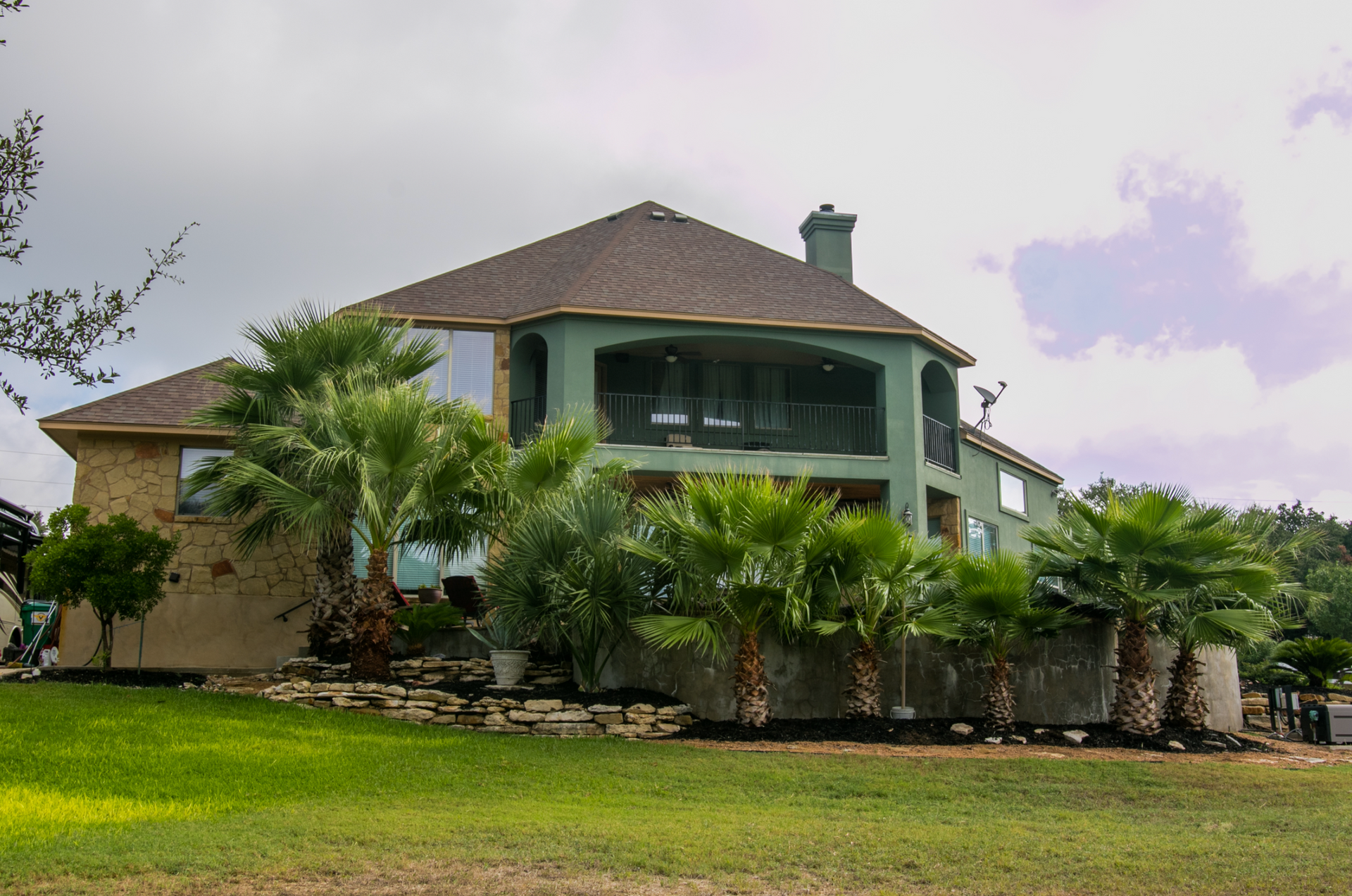 A large house with palm trees in front of it