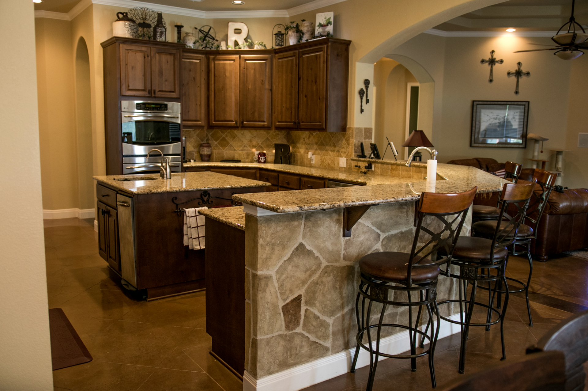 A kitchen with wooden cabinets and granite counter tops