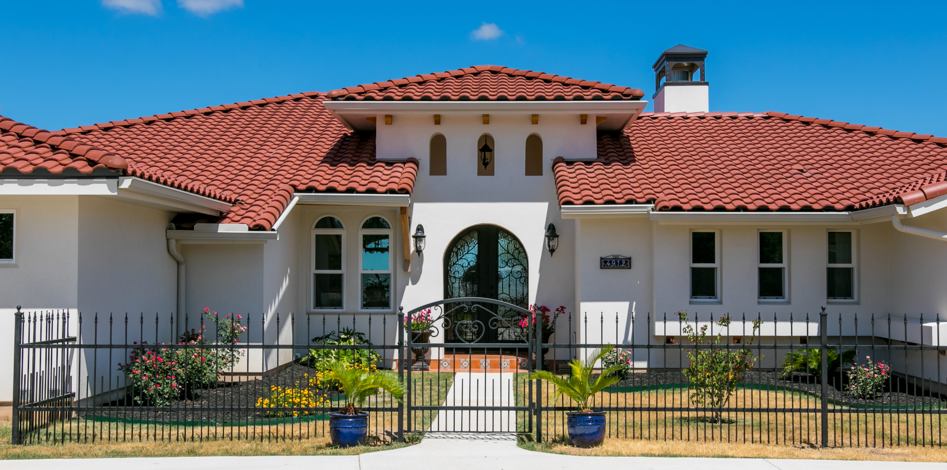 A large white house with a red tile roof