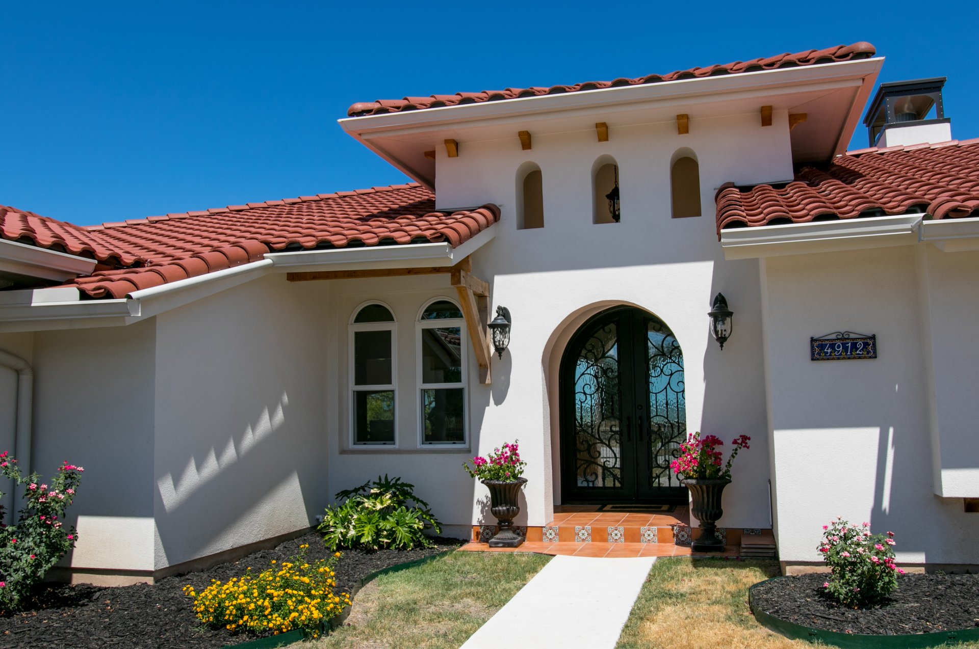 A large white house with a red tile roof
