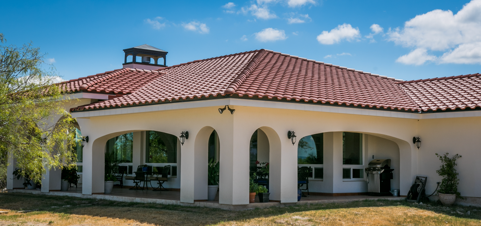 A large white house with a red tile roof