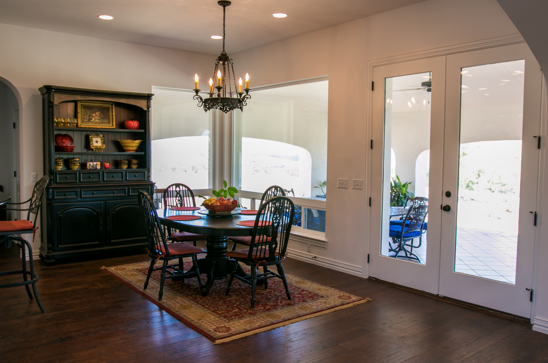A dining room with a table and chairs and a chandelier.