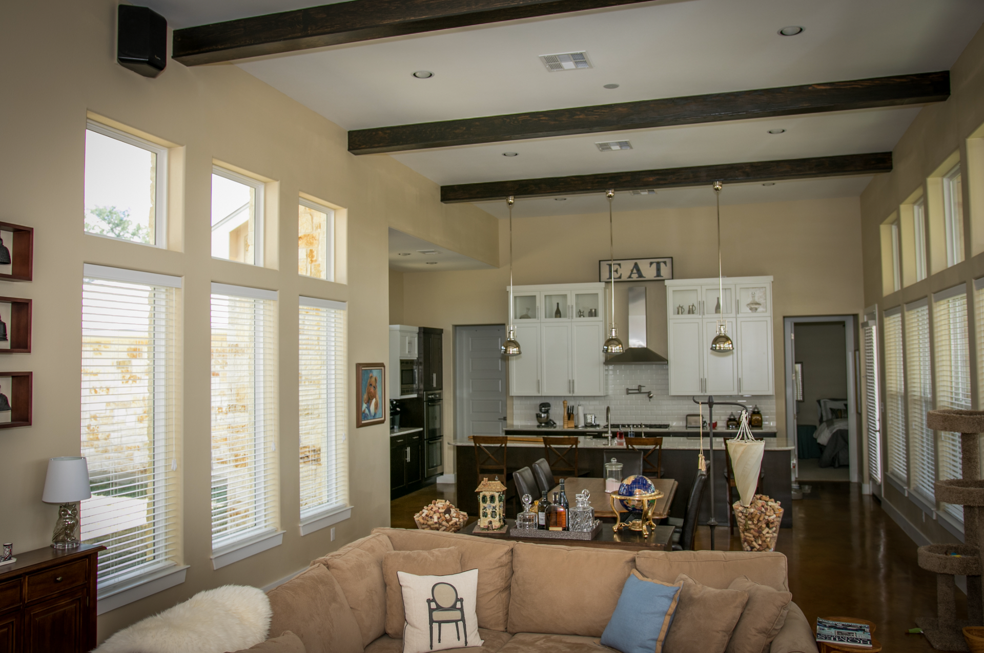 A living room with a couch and a kitchen in the background