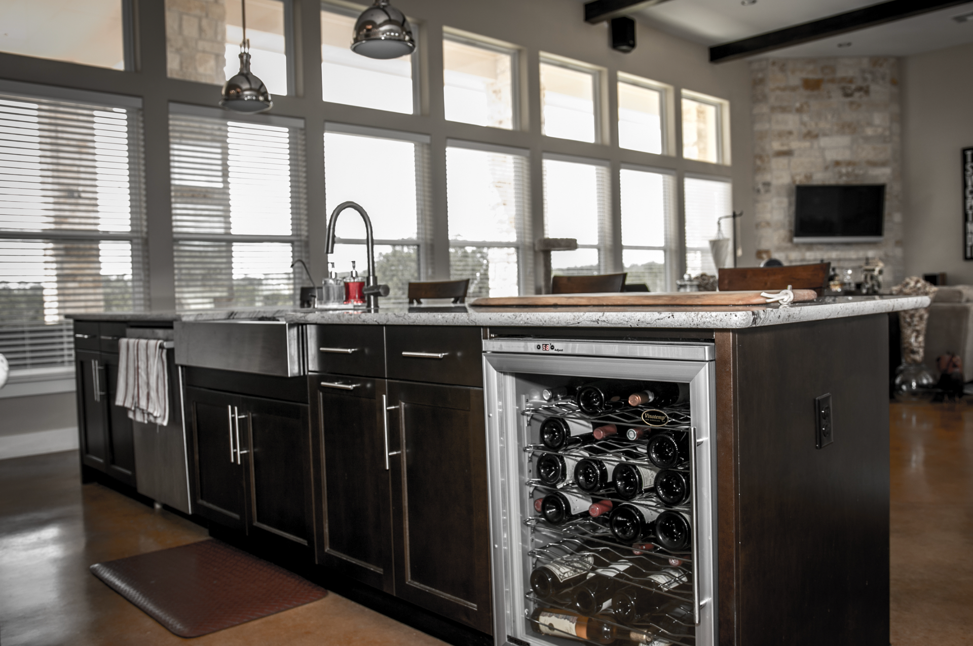 There is a wine cooler in the middle of the kitchen.