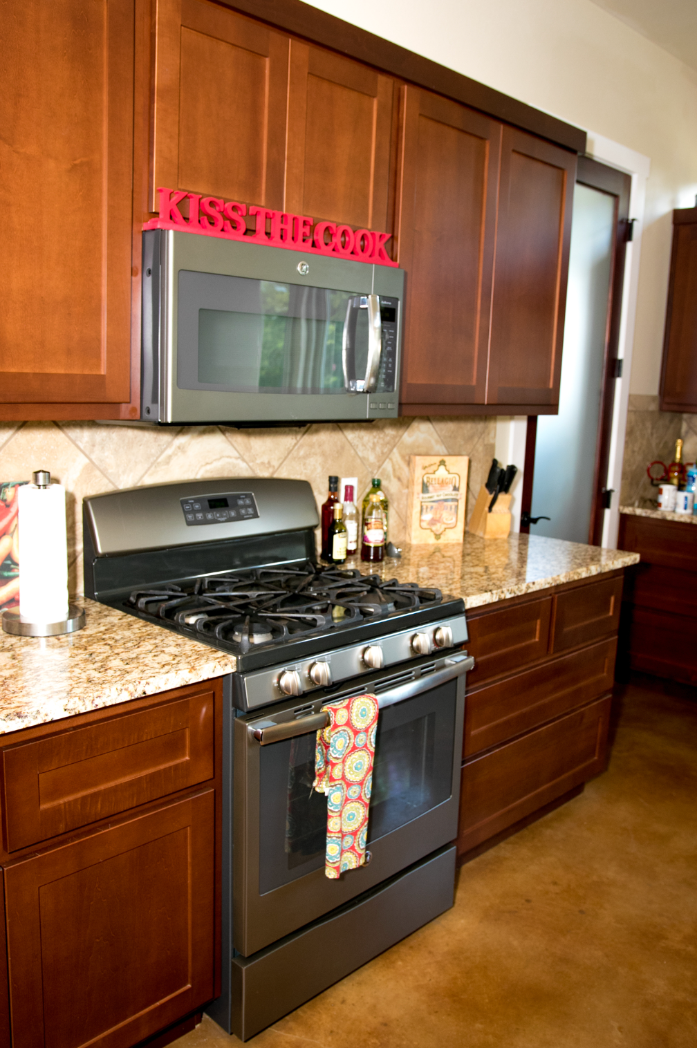 A kitchen with a stove top oven and a microwave above it