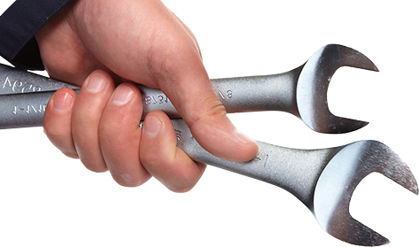 Hand gripping two silver wrenches against a white background. | Denton Auto Care And Tire
