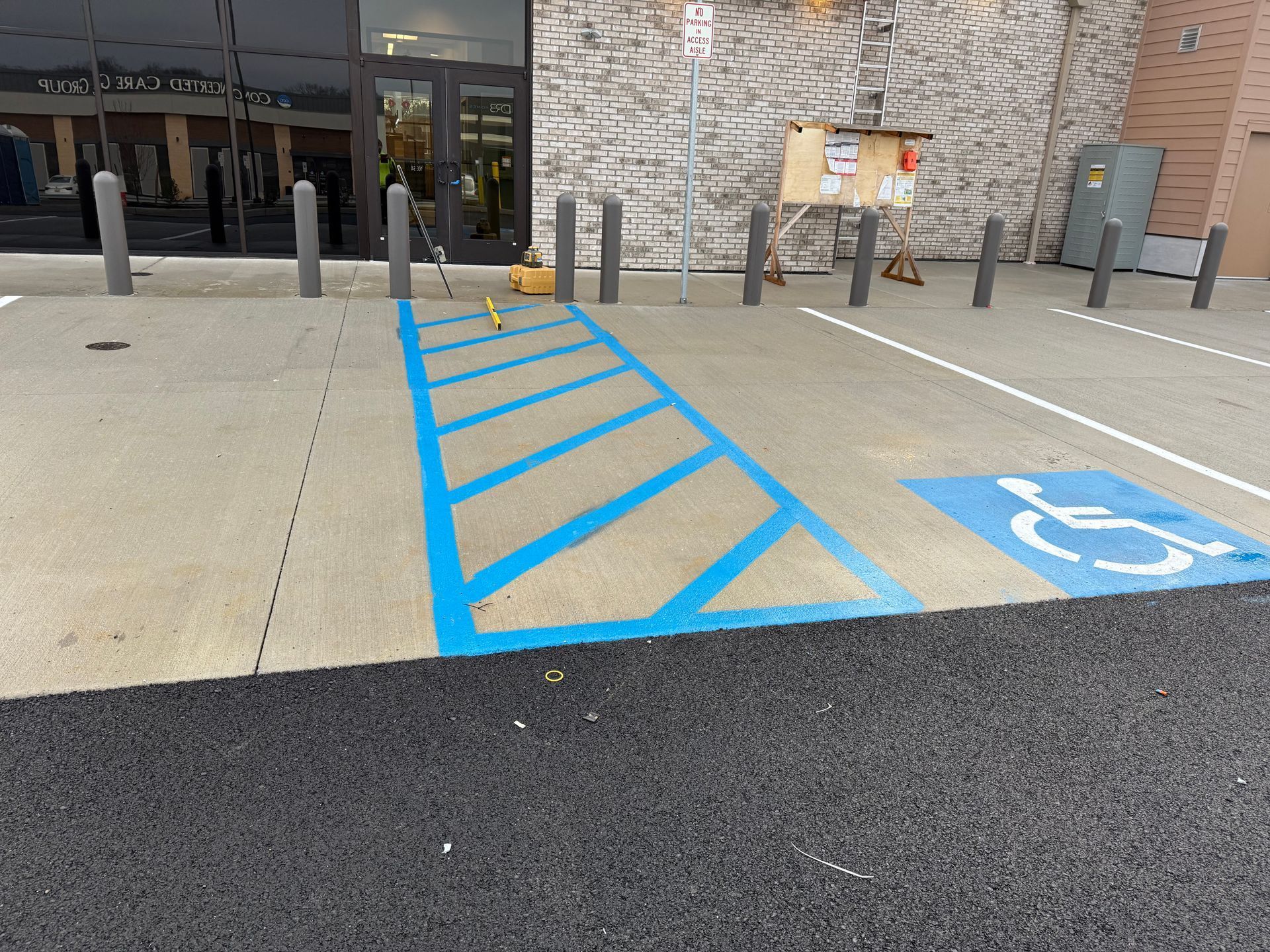 Accessible parking space with blue hatch markings beside a building entrance