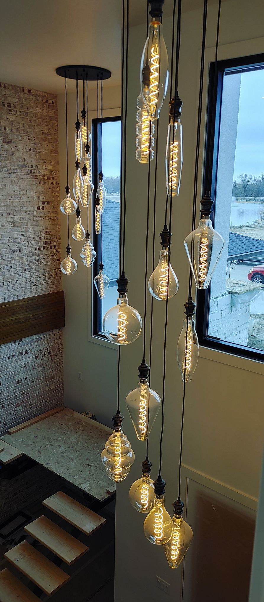A bunch of light bulbs are hanging from the ceiling in a room.