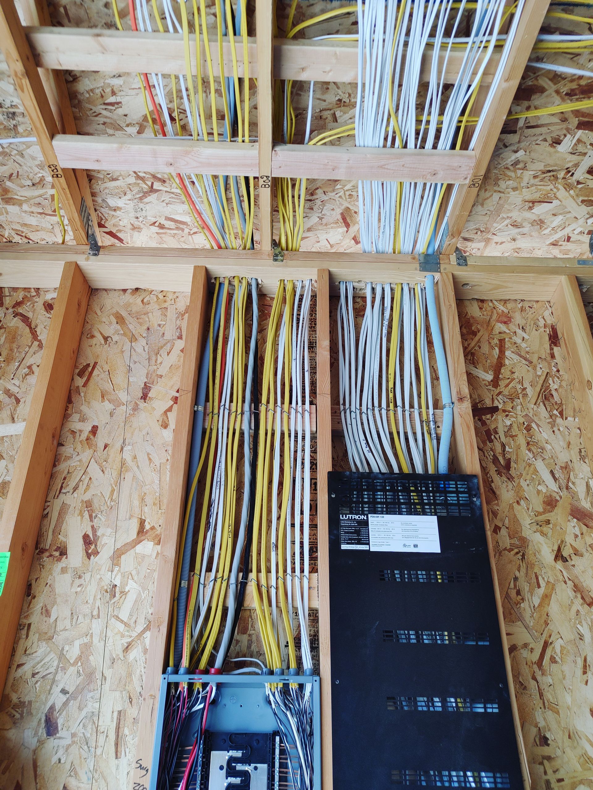 A bunch of wires are hanging from the ceiling of a building.
