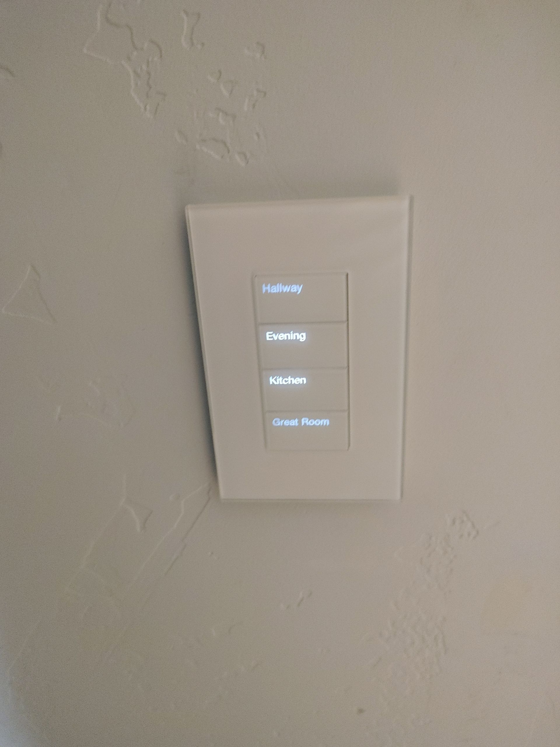 A white light switch is hanging on a white wall.